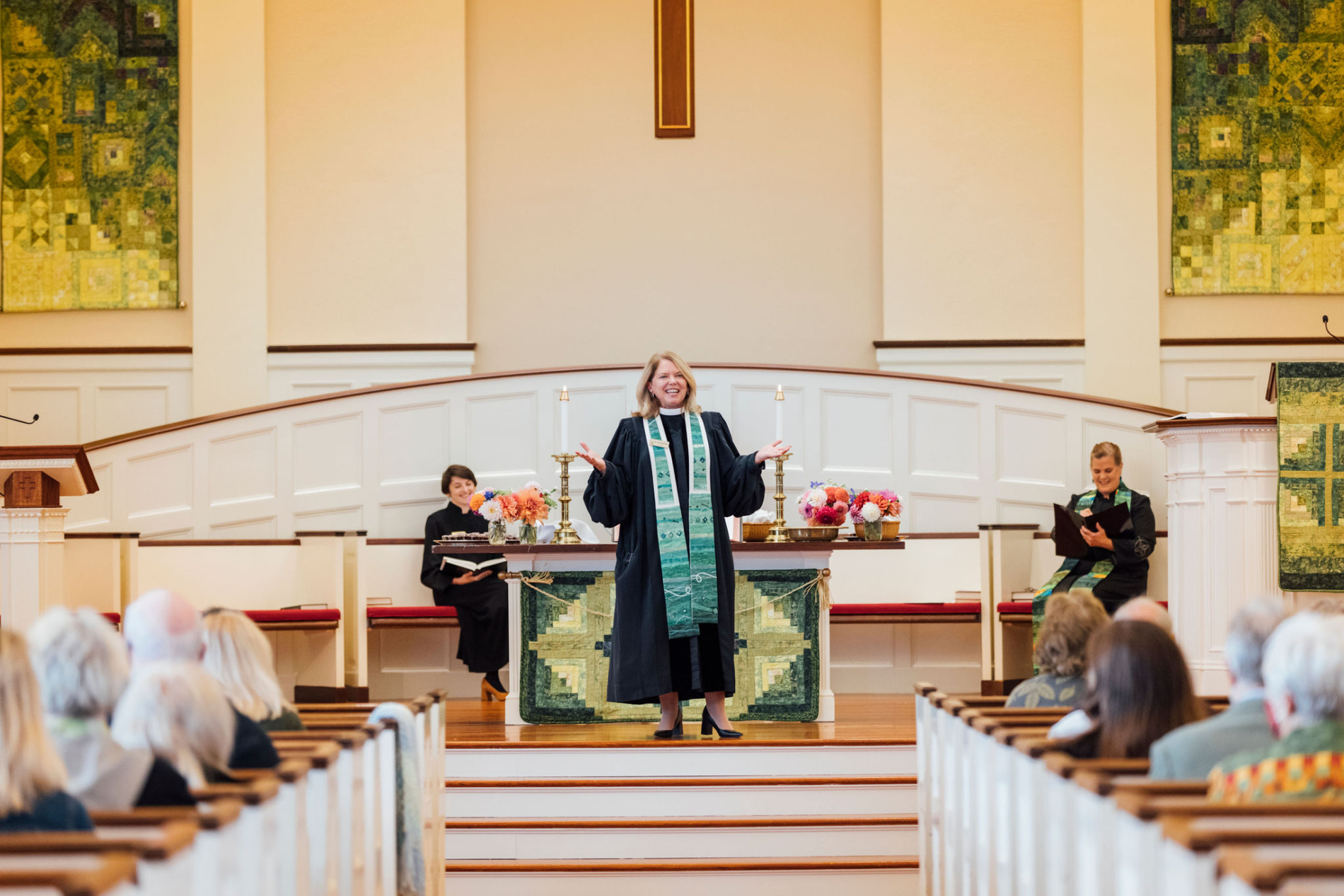 Pastor greets congregation in sanctuary