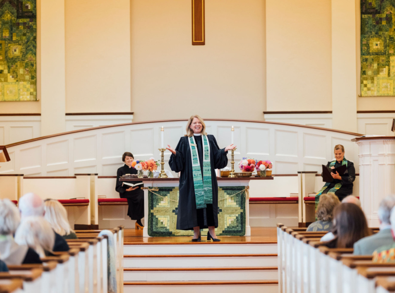Pastor greets congregation in sanctuary
