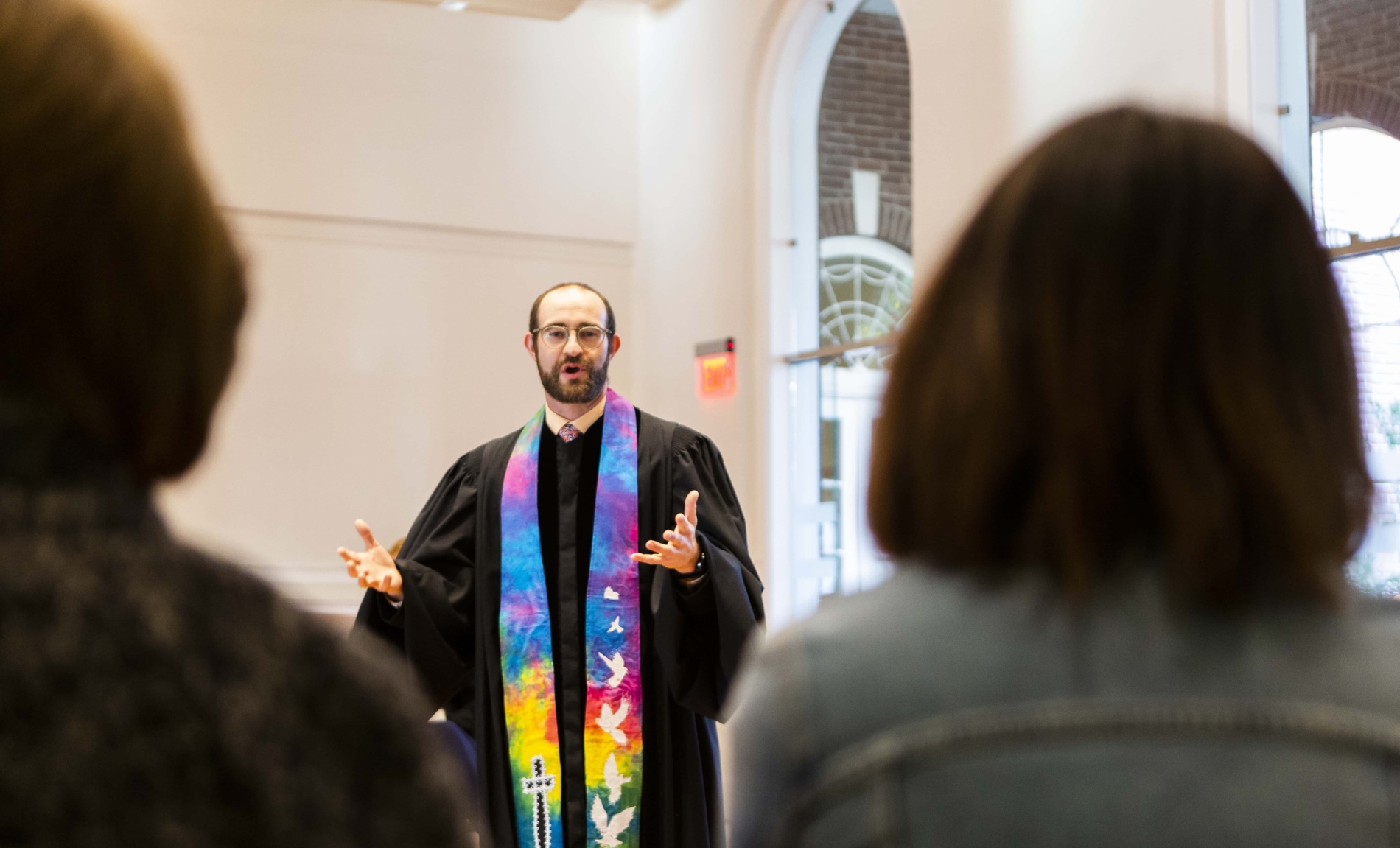 Bob Feeny, pastoral resident, preaches to people in the chapel
